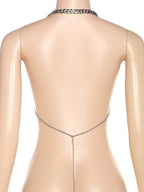 Top corto con cadena metálica y espalda descubierta 