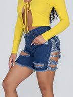 Shorts vaqueros desgastados hasta la rodilla con roturas elásticas 